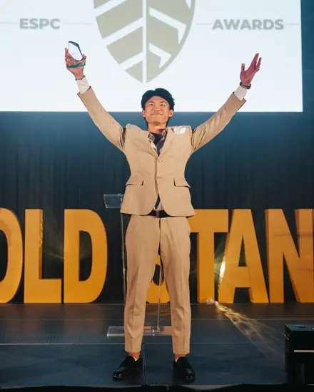 A rep celebrating on stage at the company awards