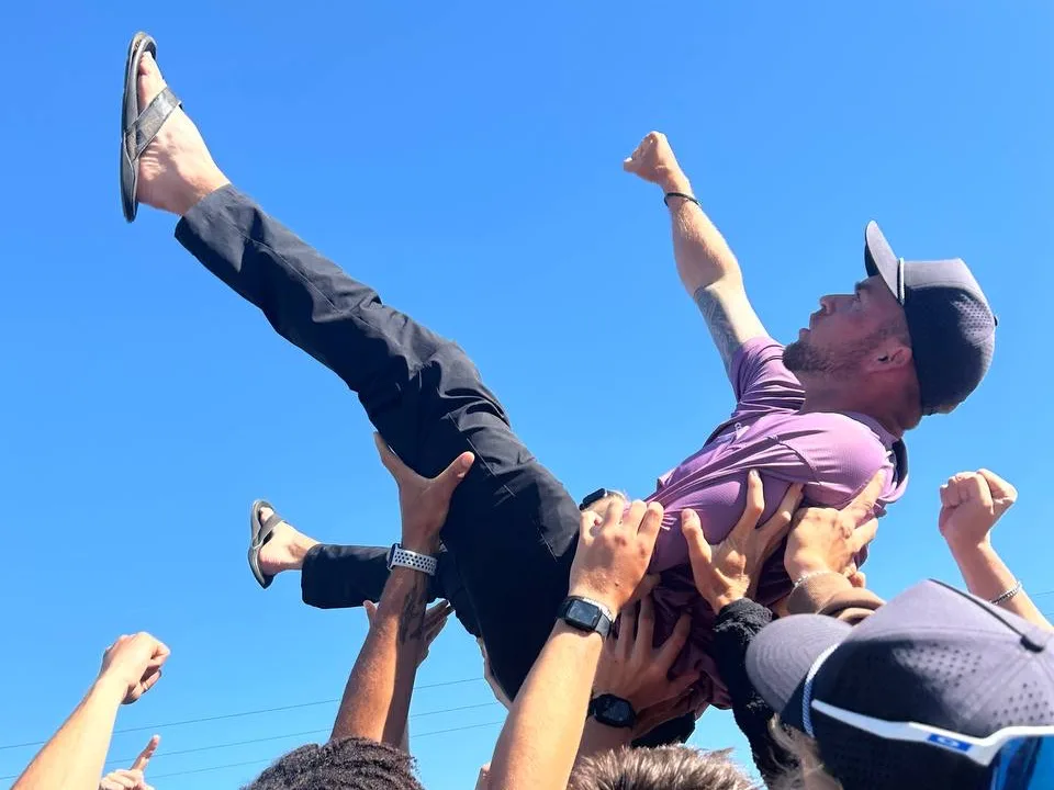 A rep lifted overhead by teammates at an Ecoshield celebration